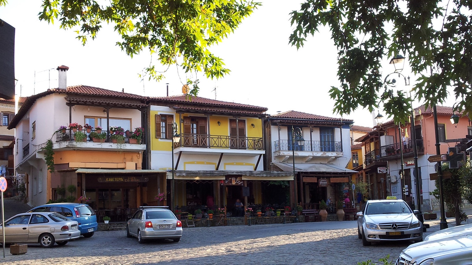 Πλακόστρωτος δρόμος, αυτοκίνητα και σπίτια στην Αρναία Χαλκιδικής 