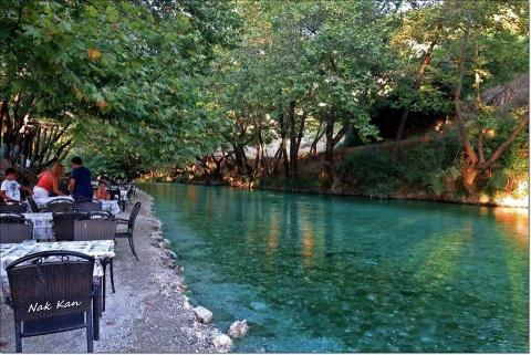 Τραπέζια και κόσμος σε ταβέρνα δίπλα στον ποταμό Αχέρωντα